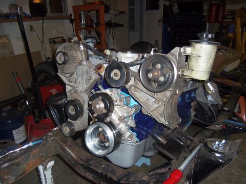 1968 Ford Bronco - Engine assembly, likely a Ford Bronco, is shown mounted on a frame in a workshop setting.