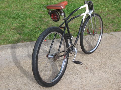 1994 Ford Bronco - A custom bicycle with a vintage aesthetic is parked on a concrete surface.