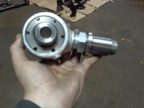 1995 Ford F-150 - A metal suspension joint, likely for a vehicle's steering or suspension system, is held in a person's hand.
