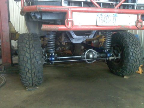 1995 Ford F-150 - Front suspension and axle of a modified 1995 Ford F-150, showing custom work.