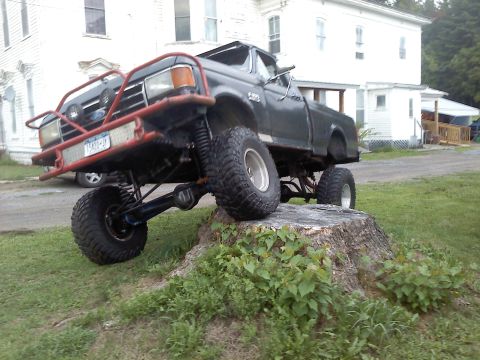 1995 Ford F-150 - This modified Ford F-150 pickup truck is shown with a lifted suspension and custom front bumper.