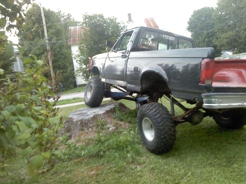 1995 Ford F-150 - Modified 1995 Ford F-150 pickup truck with off-road tires and suspension lift.