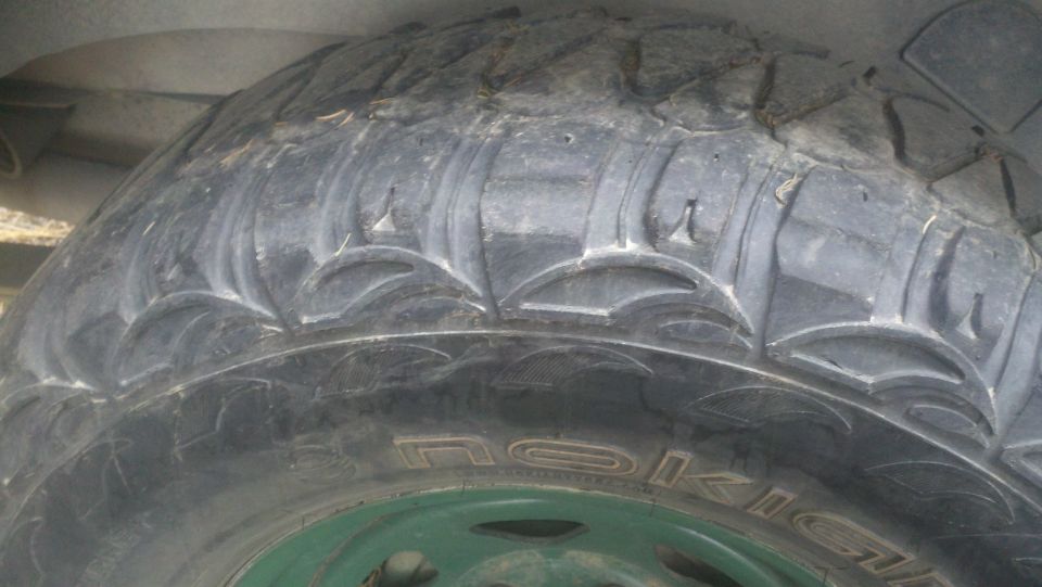 Close-up of a tire with aggressive tread pattern and visible text 'NOKIAN'