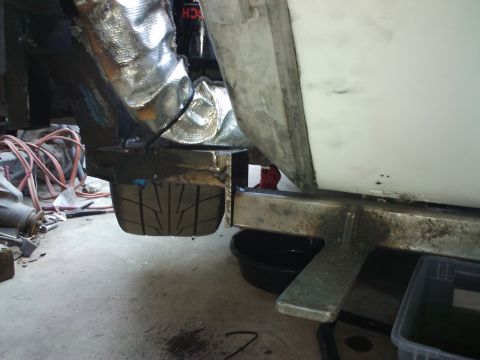 1995 Ford Probe - A close-up view of a vehicle's undercarriage, revealing a tire and exhaust system components.