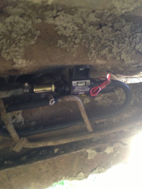 1979 Ford Bronco - Close-up of an aftermarket electric fuel pump assembly mounted under a vehicle.