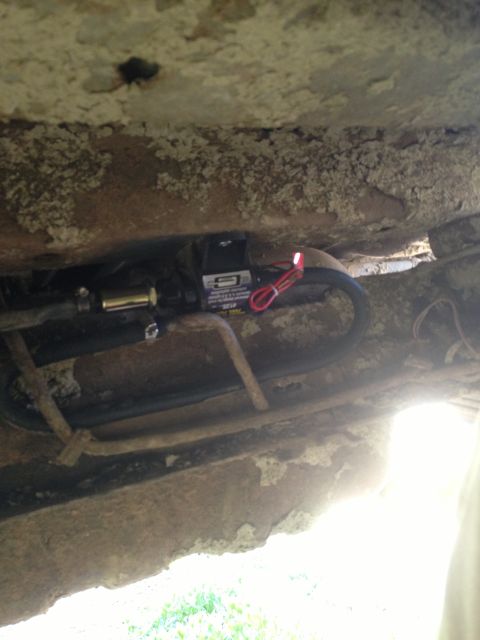 1979 Ford Bronco - An electric fuel pump is mounted to the undercarriage of a vehicle.