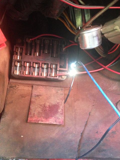 1979 Ford Bronco - A close-up view of a vehicle's fuse box and associated wiring, showing multiple fuses and electrical connections.
