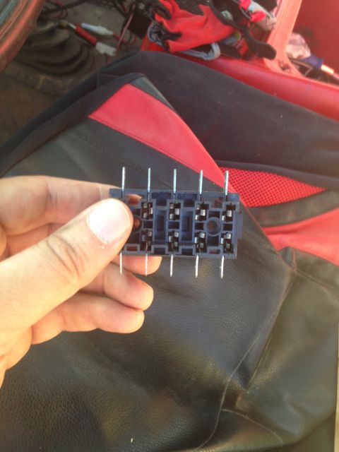 1979 Ford Bronco - Close-up of a hand holding a relay socket, likely for automotive use.