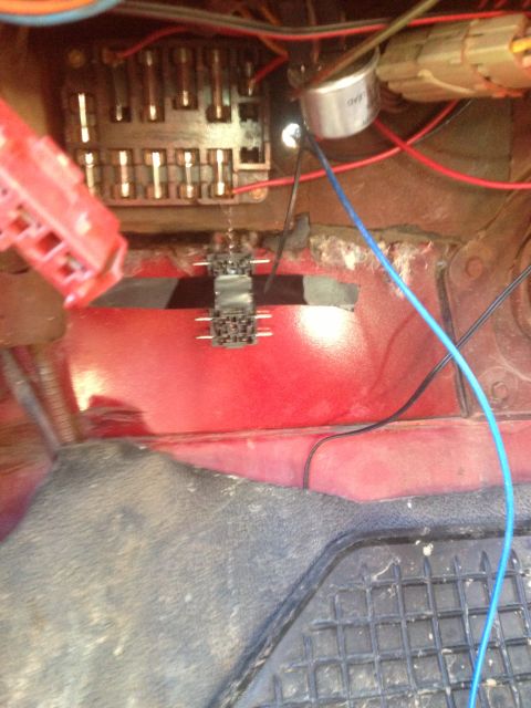 1979 Ford Bronco - This image shows the fuse box and wiring harness inside a vehicle's cabin.
