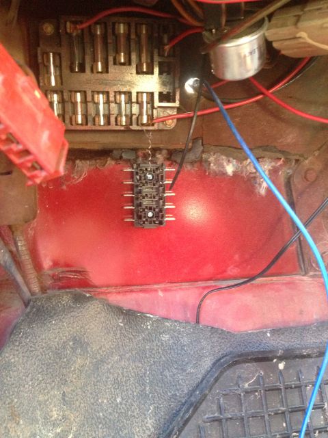 1979 Ford Bronco - Close-up view of a vehicle's fuse box and associated wiring, showing multiple fuses and connectors.