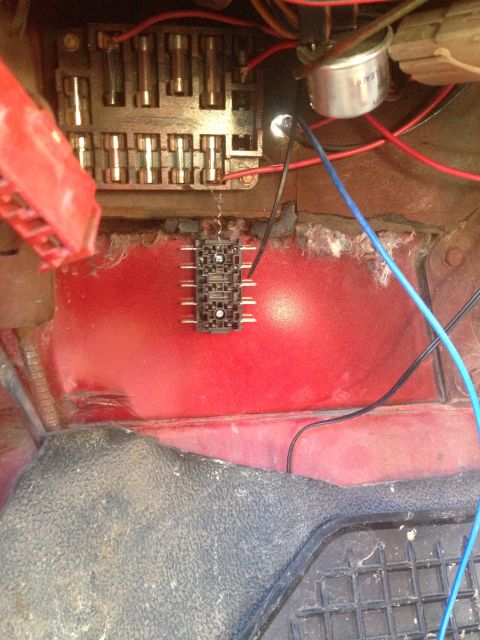 1979 Ford Bronco - Close-up view of a vehicle's fuse box and associated wiring, showing multiple fuses and a relay block.