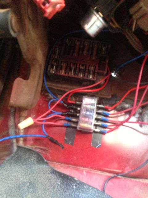 1979 Ford Bronco - Close-up view of a vehicle's electrical wiring and fuse box with an inline fuse holder.