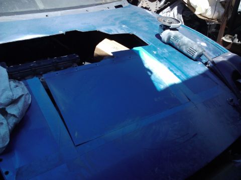 1995 Ford Probe - Car hood being modified with a cut-out and an angle grinder nearby.