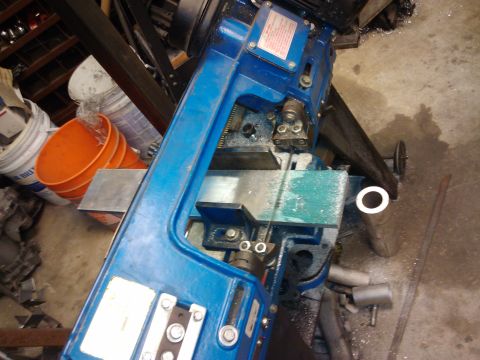 1995 Ford Probe - A blue metal cutting band saw is shown in a workshop setting, with various tools and buckets in the background.