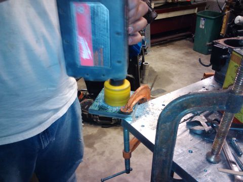 1995 Ford Probe - Metalworking in progress: a hole saw is used to cut a circular opening in a clamped metal sheet.