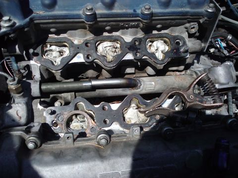 1995 Ford Probe - Close-up of engine intake manifold gaskets removed for service, with ports temporarily plugged.