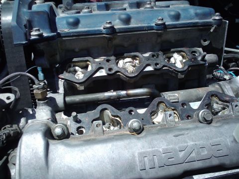 1995 Ford Probe - Close-up view of a Mazda engine with the intake manifold gaskets removed, revealing the internal components.