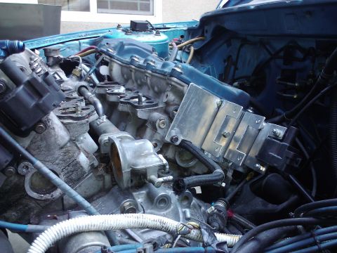 1995 Ford Probe - Close-up view of a car's engine bay, focusing on the intake manifold and associated components.