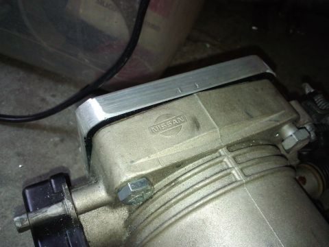 1995 Ford Probe - A close-up view of a Nissan throttle body, possibly modified with an aftermarket adapter plate.