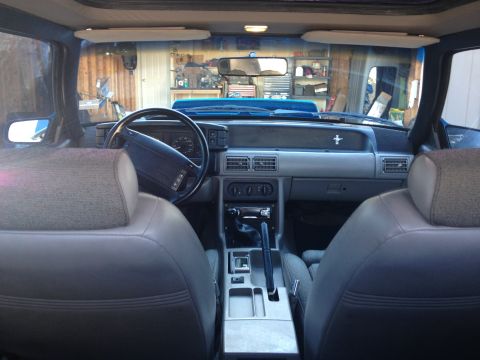 1990 Ford Mustang - Interior view of a 1990 Ford Mustang, highlighting the dashboard and seating.