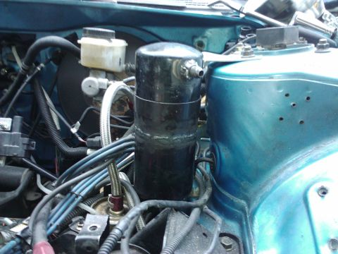 1995 Ford Probe - Close-up view of engine bay components, including a black cylinder and brake fluid reservoir.