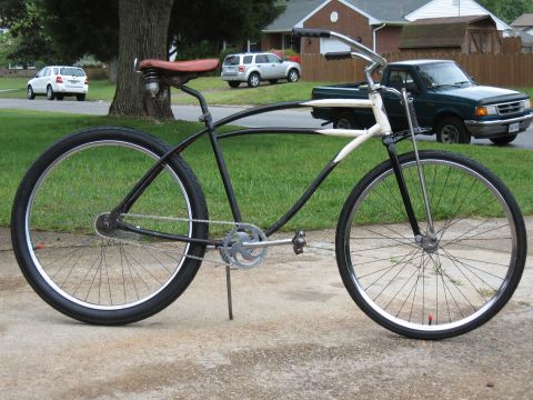 1994 Ford Bronco - A cruiser bicycle is parked on a driveway with vehicles in the background.