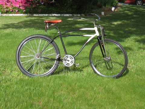 1994 Ford Bronco - A vintage-style bicycle with a distinctive frame design and wide tires is displayed outdoors on a sunny day.