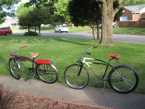 1994 Ford Bronco - Two vintage bicycles are parked on a sidewalk in front of a residential area.