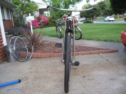1994 Ford Bronco - A vintage bicycle is parked on a driveway, with another bicycle in the background.