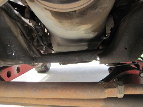 1989 Ford Bronco - Close-up view of the undercarriage, focusing on the frame and suspension parts.
