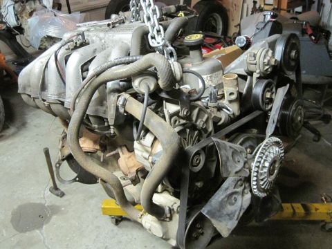 1989 Ford Bronco - Engine assembly is suspended by chains, ready for installation or removal.