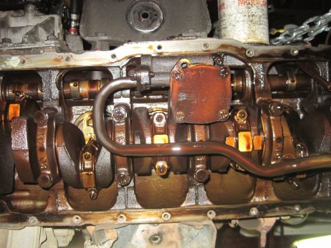 1989 Ford Bronco - Close-up view of an engine's crankshaft and connecting rods, showing internal components.