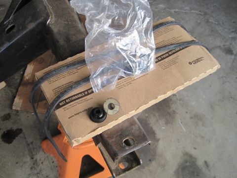 1989 Ford Bronco - New engine mounts and belts are packaged in a box, ready for installation.