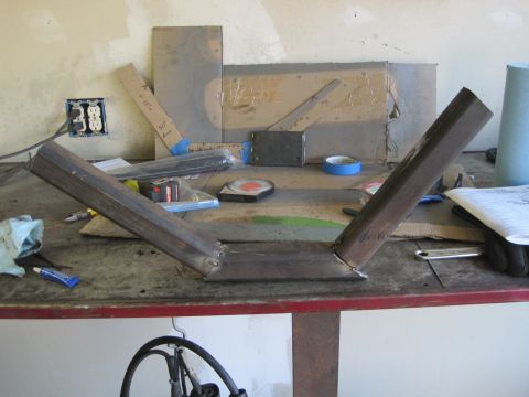 1989 Ford Bronco - Various engine parts are organized on a workbench, suggesting a mechanical project or maintenance.