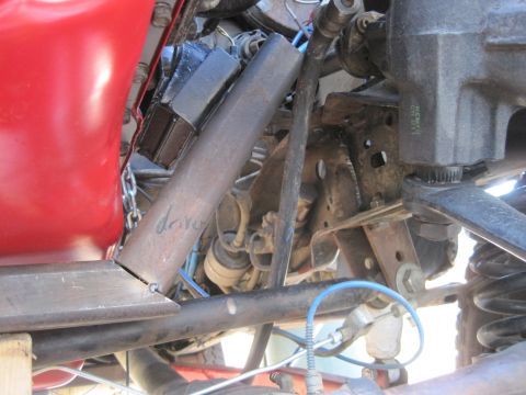 1989 Ford Bronco - Close-up view of engine and suspension components, with handwritten text on a metal tube.