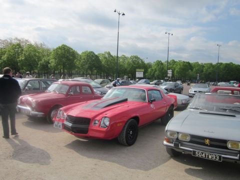 1991 Ford LTD Crown Victoria - A red 1978 Chevrolet Camaro is parked in a lot with several other vehicles.