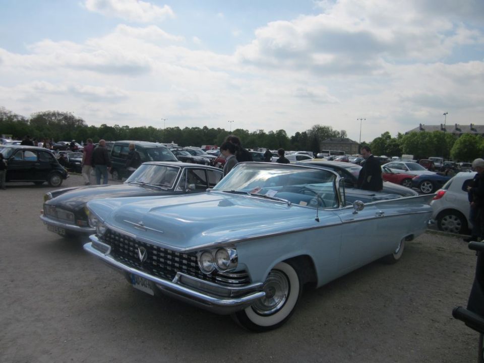 Light blue 1959 Buick LeSabre convertible parked in a lot with other cars