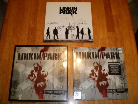 1997 Ford Probe - Three items related to Linkin Park's 'Hybrid Theory' are displayed on a wooden surface.