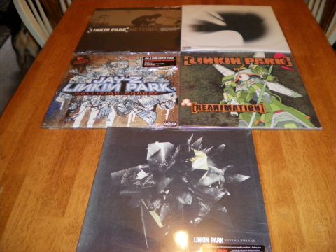 1997 Ford Probe - A collection of Linkin Park albums, including Meteora and Reanimation, are displayed on a table.