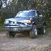 1988 Ford Bronco - This 1987 Ford F-250 pickup truck is parked outdoors on a dirt road.