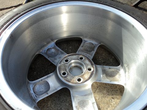 2004 Mercury Grand Marquis - Close-up of a used aluminum wheel, with visible dirt and minor imperfections on its surface.