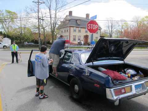 1991 Ford Crown Victoria - A dark blue police car is parked with its trunk and driver's door open, while two people stand nearby.