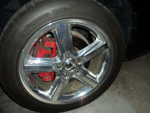 2004 Mercury Grand Marquis - Close-up of a vehicle's wheel and red brake caliper.