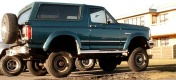 1996 Ford Bronco - This Ford Bronco is parked outdoors with other vehicles visible in the background.