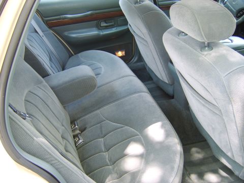 1996 Mercury Grand Marquis - The plush velour interior of a 1996 Mercury Grand Marquis, comfortable rear seating and wood trim accents.