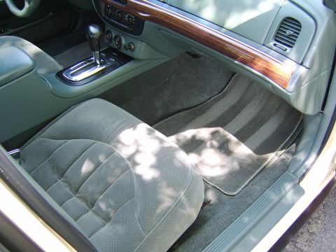 1996 Mercury Grand Marquis - The interior of a 1996 Mercury Grand Marquis features wood trim and plush seating.