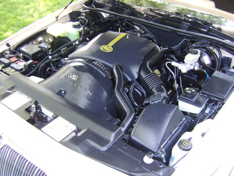 1996 Mercury Grand Marquis - Close-up view of a V8 engine bay, showing the fan shroud and engine cover.