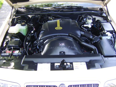 1996 Mercury Grand Marquis - The engine bay is clean and shows the V8 engine with a prominent caution fan warning.