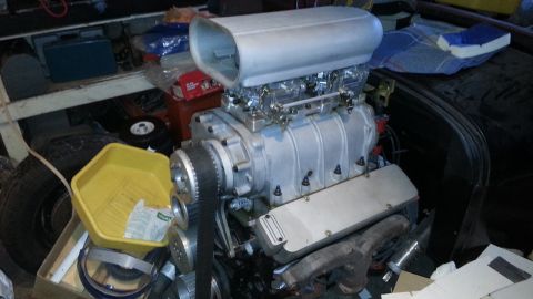 2005 Ford Mustang - Engine parts including a supercharger are visible in a cluttered garage setting.