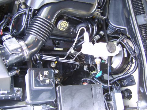 1996 Mercury Grand Marquis - Close-up view of the engine compartment, showing the air intake system and brake fluid reservoir.